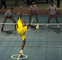 Three players ready to return serve in the game of sepak takraw
