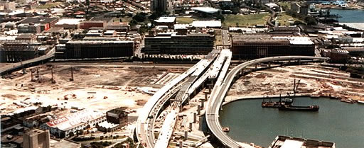 Aerial view of Pyrmont showing a half built road that will become the Western Distributor. The wider area is leveled brown dirt.