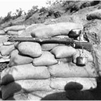 Drip rifle supported by sandbags