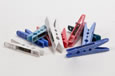A collection of red, blue and white plastic clothes pegs.