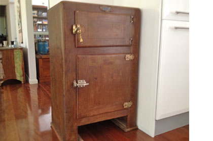 Large brown standing chest with a small door and large door at the front.