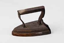 An old rusted iron with a small body and large handle
