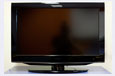 A black flat screen television with a stand.
