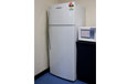 A large two door white refrigerator