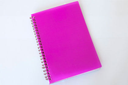 Notebook with spiral binding along left hand edge