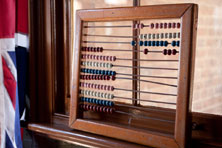An abacus with a wooden frame and coloured beads