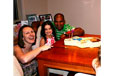 Mum, dad and child celebrating a birthday with a cake.