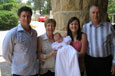 Four adults and a baby in a christening gown.