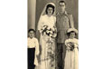 A bride and groom with a page boy and flower girl.