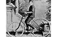 A boy on a bicycle.