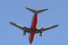 A red and silver jet with two engines