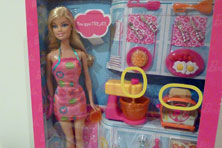 A packaged teenage doll with kitchen objects