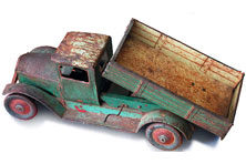 A rusty old tip truck toy made of metal