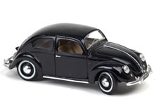 An old black Volkswagen beetle toy car