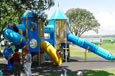 Blue and yellow outdoor play equipment with slides.