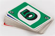 A pack of cards with a green and white card displaying the number 5 on top.