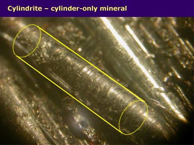 a close-up view of long round crystals with cylinder shape highlghted