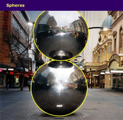 a metal sculpture of two balls with the spherical shapes highlighted