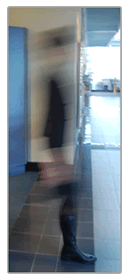 Blurred image of a person stepping into a corridor