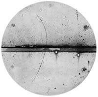 Disc shaped grainy, black and white image with a grove looking dark path from east to west of the image and a dark line path curved towards the east from the south-southwest position to north-northwest position of the image.