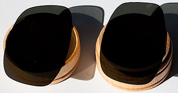 Two containers covered by sunglass lens.