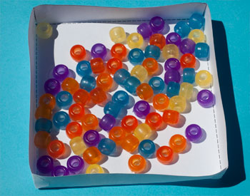 Coloured beads in a container