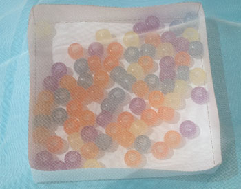 Beads in a container covered with a clothe