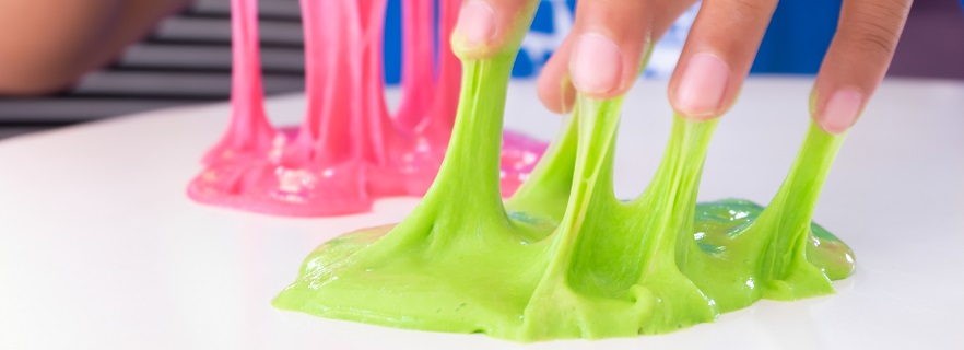 Children's fingers in green and red slime.