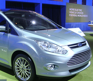 A sleek small shiny new car in a display area.