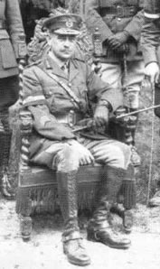 John Monash sitting in front of standing soldiers