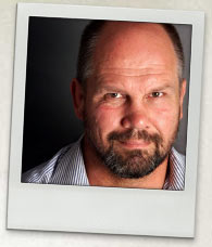 Photograph of Peter FitzSimons. He is wearing a striped shirt in a portrait shot.