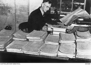 Charles Bean writing the 'Official History' at Victoria Barracks, surrounded by Operation Files.