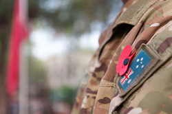 close up of soldier in uniform wearing poppy
