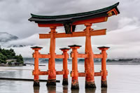 Shinto thumbnail: an orange-red torii gate in a lake; it has a curved top beam supported by pillars