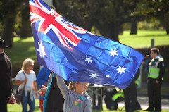 Young girl waving a large Australian national flag