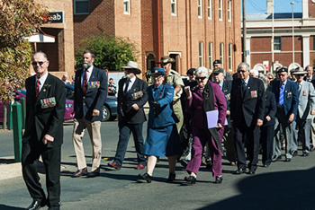 Men and women marching down a road