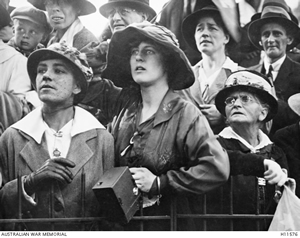 A group of women and men are looking up expectantly.