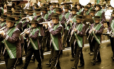Young people marching in uniform playing instruments