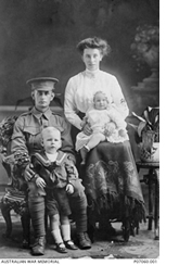 Studio photo of a soldier with his wife and two children