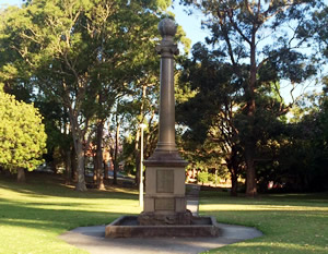 A tall, thin monument in a park.