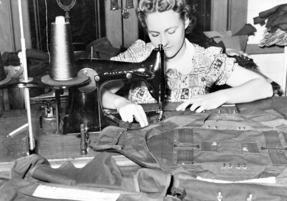 Woman at sewing machine making uniforms
