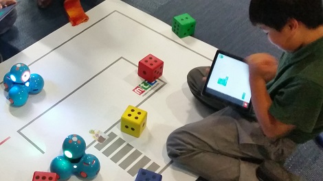 Students navigating a maze with Dash using an iPad