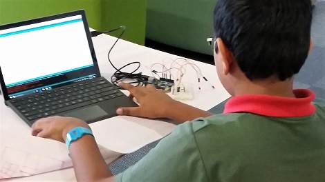Student coding an Arduino LED light show with a computer
