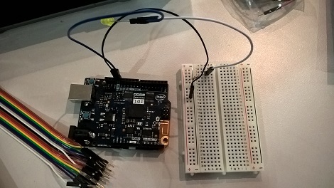 Arduino microcontroller and peripherals including a breadboard and some coloured jumper wires