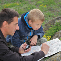 Student and teacher looking at map outdoor